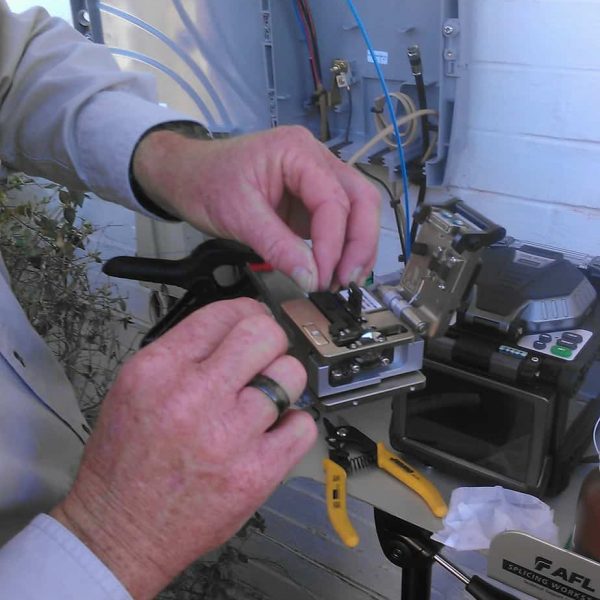 Employee Jimmy Ridgeway prepares to cleave a fiber prior to splicing it. 