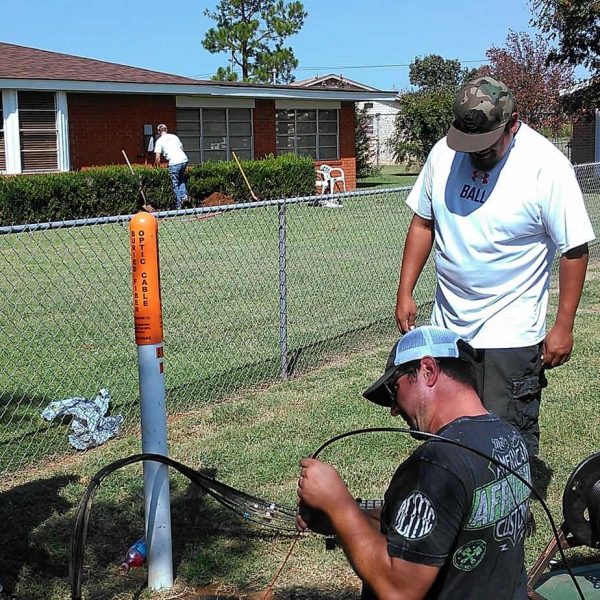 Travis Ridgeway, Henry Autaubo & Byron Clark work to pull a new line to a customer's house