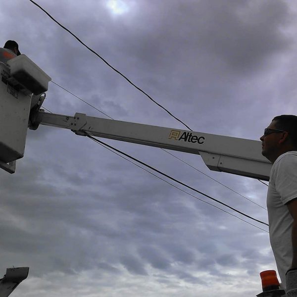 Travis Ridgeway and Shawn Lucus start the work of tearing down old copper cables in Carnegie